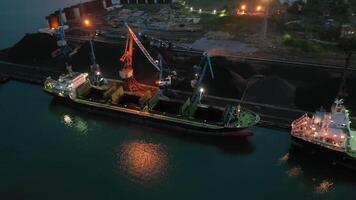 A view from a drone of cargo cranes working at night in the port video