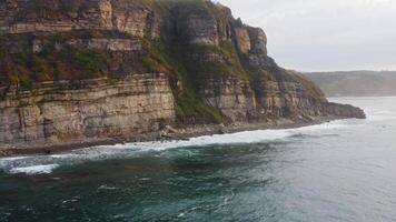 Awe-inspiring coastline. Drone view of high cliffs and raging sea video