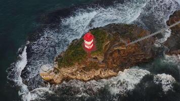 Drone view of the picturesque old Basargin lighthouse on the coast of the sea video