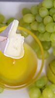 cheese with white mold Brie and grapes served with honey in a restaurant On a square plate with wooden skewers tasty delicacy expensive video