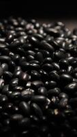 Vertical of black beans on black background, closeup of beans video