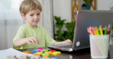 Child learning letters during online lesson at home video