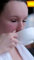 girl drinking tea in sauna sheet and relaxes on soft chaise longue in the spa zone. Slow motion video