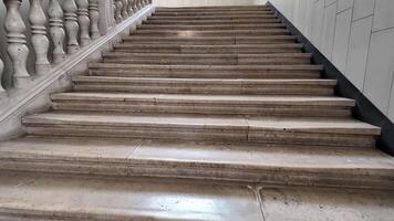 Wide stone staircase with ornate railing, ideal for historic architecture and urban exploration themes video