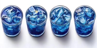 Refreshing blue drinks served in clear glasses with ice on a white surface during a sunny day, perfect for summer gatherings photo