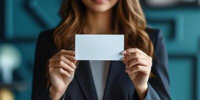 A woman in a business suit holding up a blank card photo