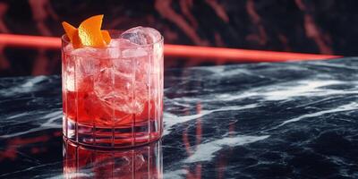 A red cocktail sitting on a marble counter photo