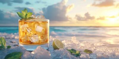 Refreshing cocktail with ice and mint near ocean at sunset on sandy beach photo