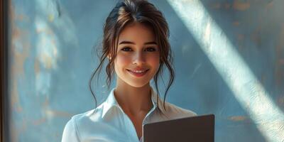 Young woman smiles confidently while holding a tablet in a modern indoor setting with natural light photo