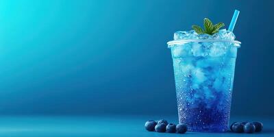 Refreshing blue drink with mint and blueberries on a cool blue background photo