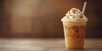 Creamy iced coffee topped with whipped cream and caramel sauce in a cozy cafe setting photo