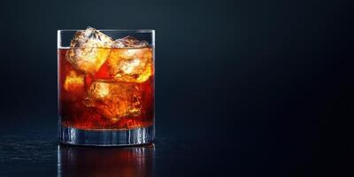Classic cocktail served over ice in an elegant glass against a dark background photo