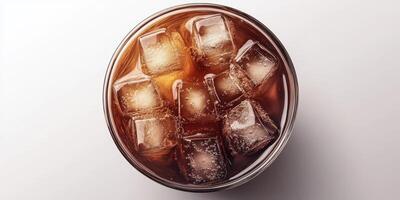 Refreshing cold beverage with ice cubes in a clear glass on a light background during a warm afternoon photo