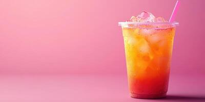 Refreshing iced beverage served in a clear cup against a vibrant pink background photo