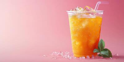 Refreshing fruity drink with ice and mint leaves on a pink background in a casual setting photo