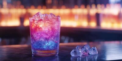 Colorful cocktail served on a bar top with ice and vibrant background lighting photo