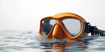 Bright orange scuba mask half-submerged in clear water creates a striking underwater scene photo