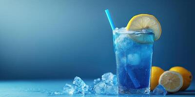 Refreshing blue lemonade served with ice and lemon slices on a blue background in a summer setting photo