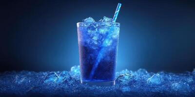 Refreshing blue drink with ice in a glass and a straw on a dark background photo
