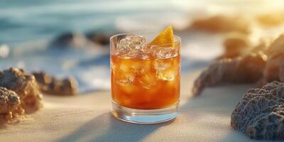 Cocktail on the Beach during Sunset with Orange Slice and Ice Cubes photo