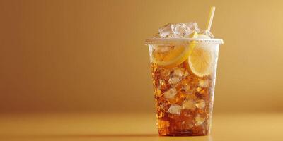 Refreshing iced tea with lemon slices served in a clear cup against a warm golden background photo