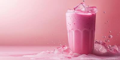 Refreshing pink beverage served in a tall glass with ice on a pink backdrop during a sunny day photo