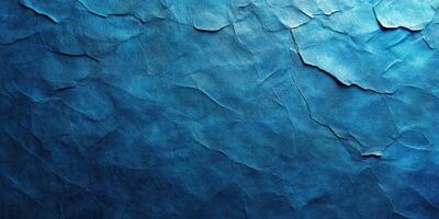 Dark blue textured background resembling crumpled paper at a close range with light variations highlighting the surface photo