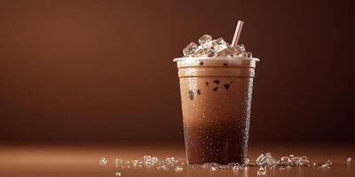 Refreshing iced coffee drink served in a clear cup with ice and condensation on a wooden surface photo