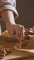 The housewife carefully sliced the champignons into fine slices using a wooden cutting board and a sharp knife. video