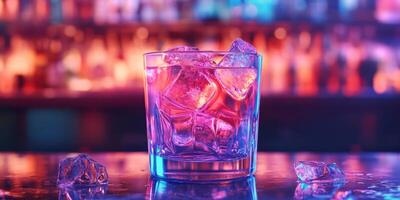 Colorful cocktail glass with ice on a bar counter illuminated by vibrant lights in a lively nightlife atmosphere photo