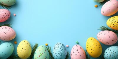 Colorful decorated eggs arranged on a pastel blue background with greenery for spring festivities and celebrations photo