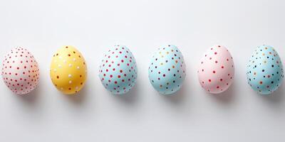 Colorful decorated eggs arranged in a line showcasing pastel patterns and vibrant dots for a festive celebration photo