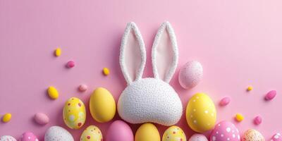 Colorful Easter decoration with bunny ears and assorted eggs on a pink background for festive celebration photo