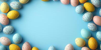 Colorful decorative eggs arranged in a circular pattern on a light blue surface for festive spring celebrations photo