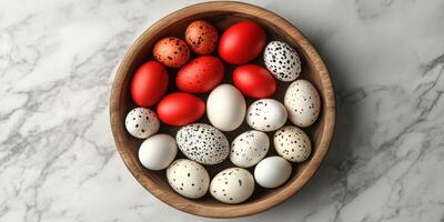 Colorful decorated eggs arranged in a wooden bowl on a marble surface during a festive celebration photo