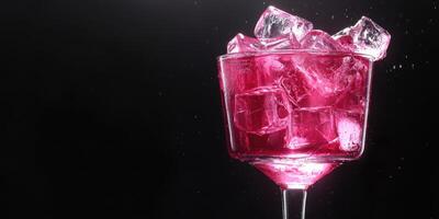 Colorful cocktail with ice cubes shimmering under dark background in a stylish glass photo