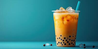 Refreshing bubble tea with peach flavor and tapioca balls served in a clear cup photo