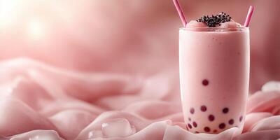 Refreshing bubble tea with pink tones served on soft fabric in a cozy setting photo