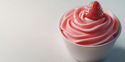 Delicious strawberry soft serve ice cream served in a white cup with a fresh strawberry on top in a bright setting photo