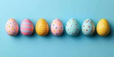Colorful decorated eggs arranged on a blue background for a festive spring celebration or Easter occasion photo