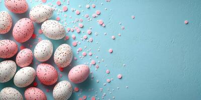 Colorful Easter eggs scattered on a blue background with decorative confetti pieces for spring celebrations photo