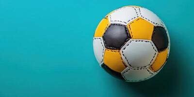 Soccer ball in a vibrant turquoise background showcasing subtle textures and colors photo
