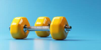 Bright yellow dumbbell resting on a blue background, ideal for fitness and workout routines photo
