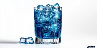 Vibrant blue drink in a glass surrounded by ice cubes on a white background photo