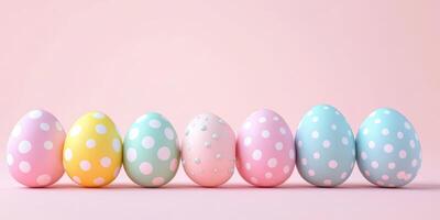Colorful polka dot easter eggs arranged in a row against a pastel pink background photo