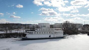 A riverboat is docked in the middle of a frozen river video
