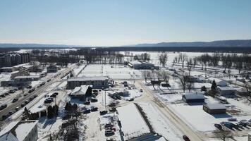 An aerial view of a snowy town with houses and trees video