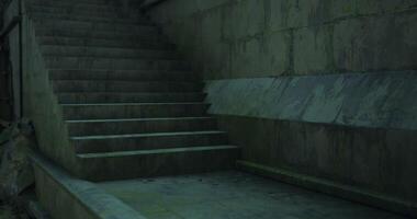 Urban stairs in a dimly lit setting with concrete textures and shadows video