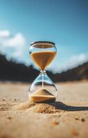 Hourglass on beach with golden sand flowing, symbolizing time and tranquility photo