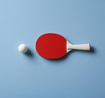 red table tennis racket and white ball on blue background create vibrant sports scene photo